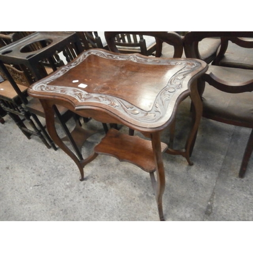 663 - A vintage 2 tier window table with carved top