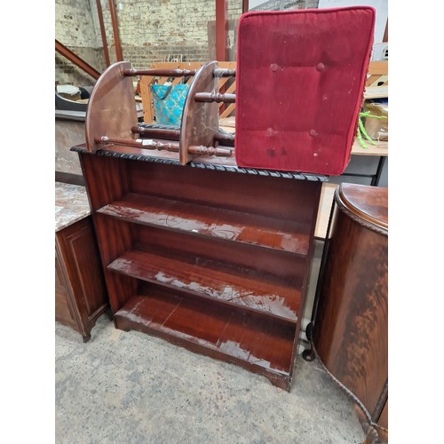 602 - A vintage mahogany open bookcase, a corner stand and an upholstered storage pouffe