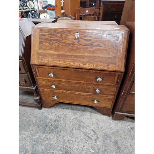 612 - A vintage 3 drawer oak bureau