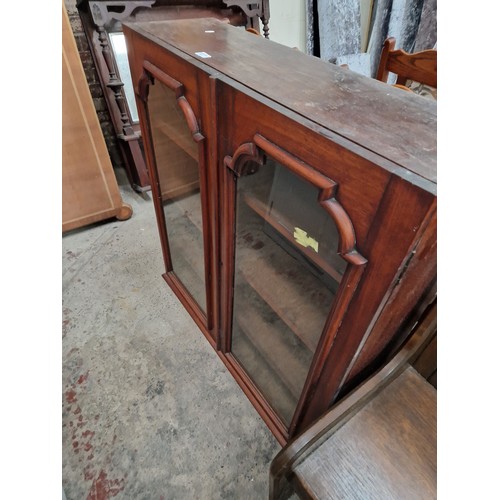 620 - A vintage glazed mahogany bookcase - one cracked glass