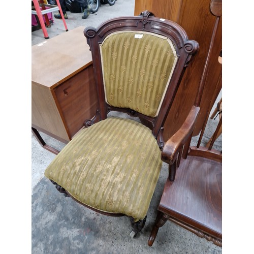 627 - An antique upholstered nursing chair with carved mahogany frame