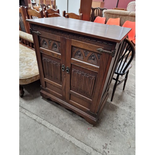 637 - A vintage carved oak 2 door TV cabinet