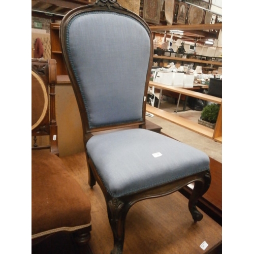 646 - A vintage upholstered nursing chair with ornately carved frame