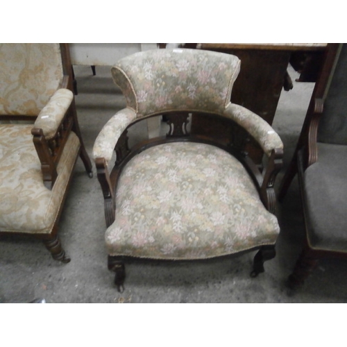 687 - A vintage upholstered tub chair with carved wooden frame