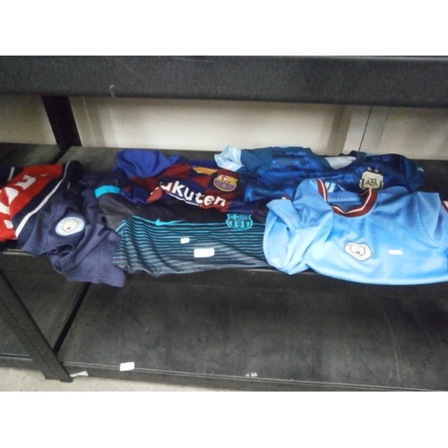 69 - Four football shirts, shorts and scarf