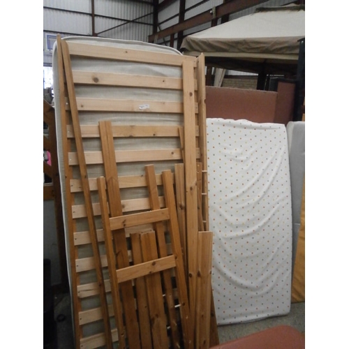 625 - A pine framed single bed with mattress and a cot mattress