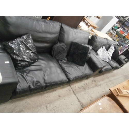 645 - A large black faux leather settee and a matching 2 seater plus cushions