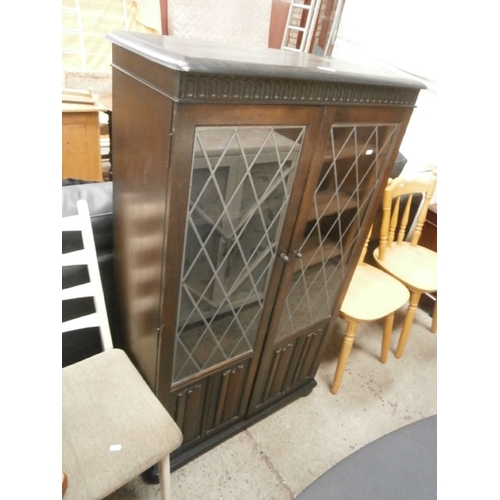 651 - A vintage bookcase with leaded glass and linenfold doors