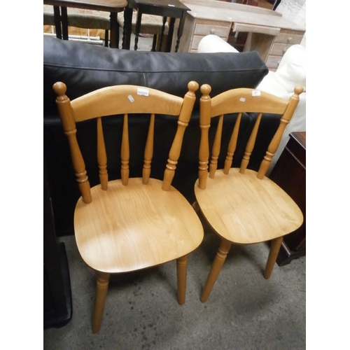 652 - A pair of spindle back kitchen chairs