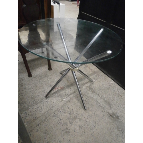 684 - A circular glass top table on chromed stand