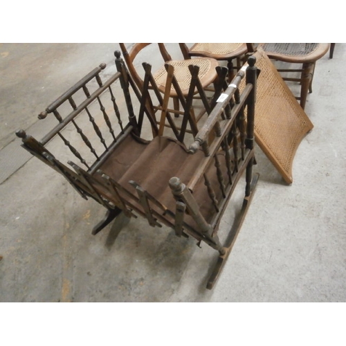 703 - A vintage rocking spindle framed folding cot