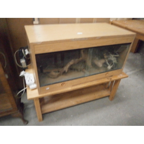A 2 tier wooden coffee table and a Vivarium with glass sliding doors