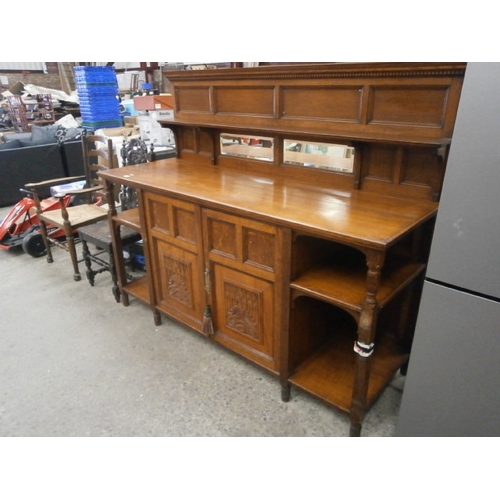 A large vintage oak sideboard unit with mirrored upstand and ornately ...