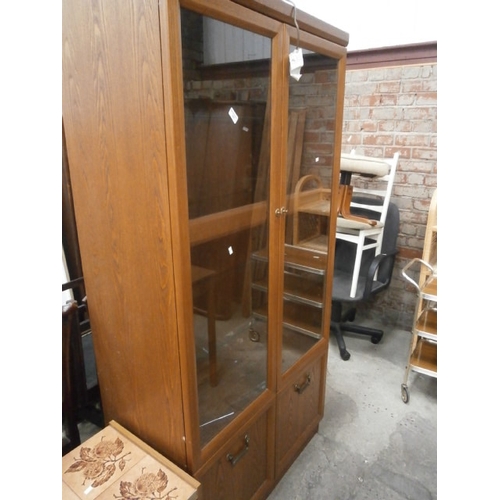 627 - A large glazed cabinet with cupboard base