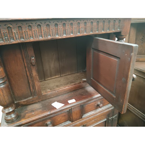 615 - A small vintage carved oak court cupboard with drawer