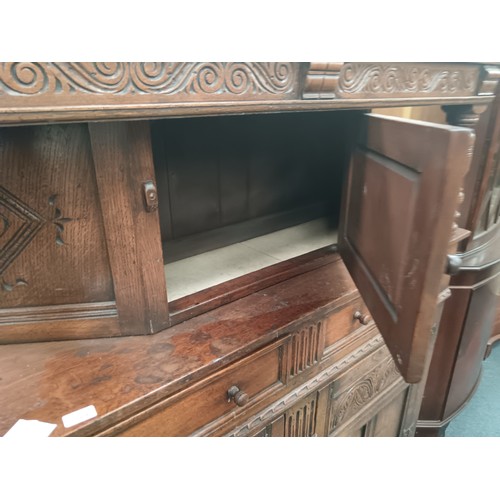 616 - A large ornately carved oak 2 drawer court cupboard