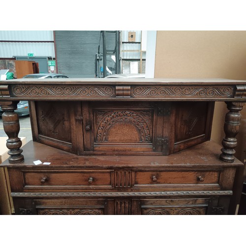 616 - A large ornately carved oak 2 drawer court cupboard