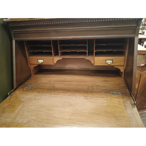 638 - A large vintage solid oak fall front bureau with lower drawer and lift front cupboard