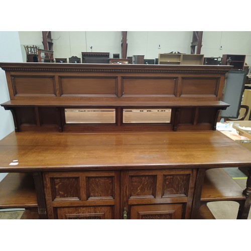 633 - A large vintage ornately carved oak mirror backed sideboard with 2 door cupboard base