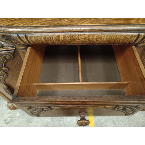 785 - A vintage ornately carved oak 4 drawer sideboard with bulbous carved upstand supports