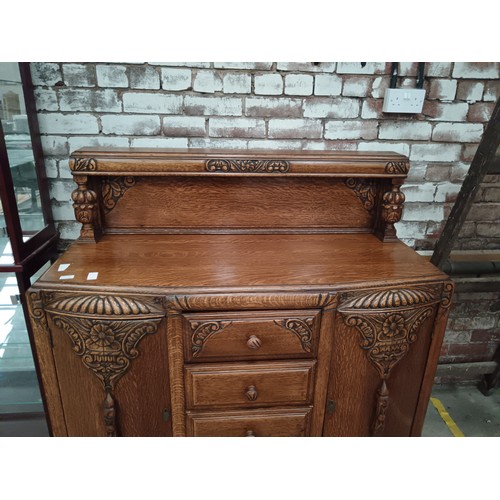 785 - A vintage ornately carved oak 4 drawer sideboard with bulbous carved upstand supports