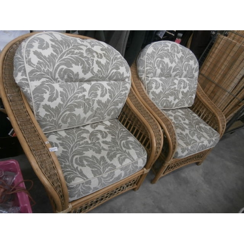 613 - A pair of large wicker conservatory armchairs with cushions