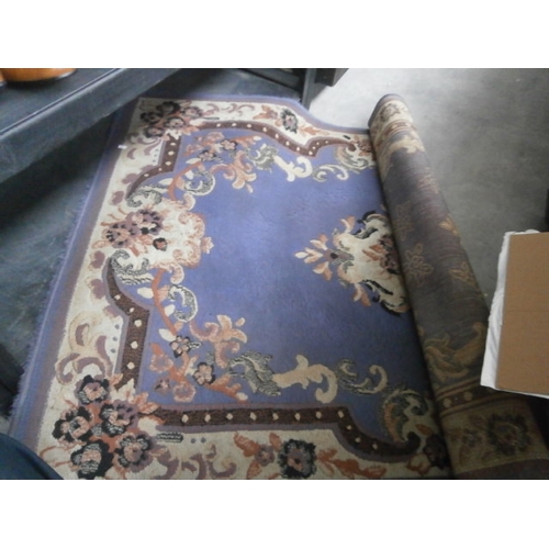 128 - Floral patterned rug.  Dimensions are L 67