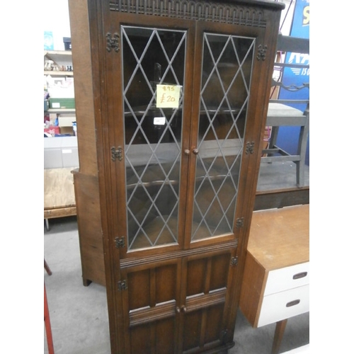 645 - A vintage 4 door corner cabinet with lead glazed doors