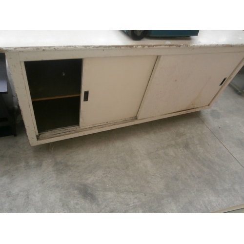 608 - A vintage low retail counter unit with sliding doors