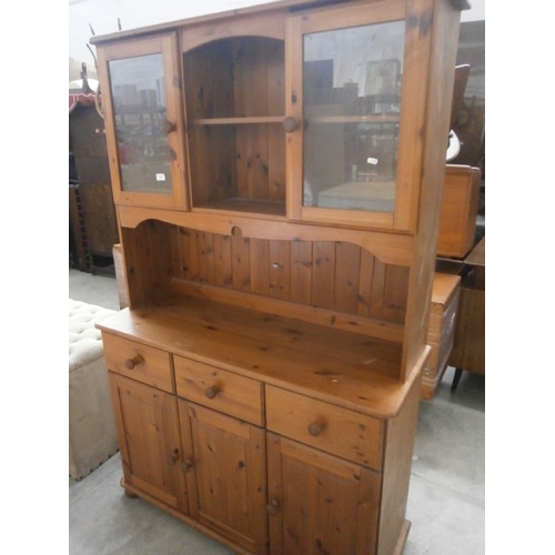 628 - A large pine 3 drawer dresser with glazed upper cabinets