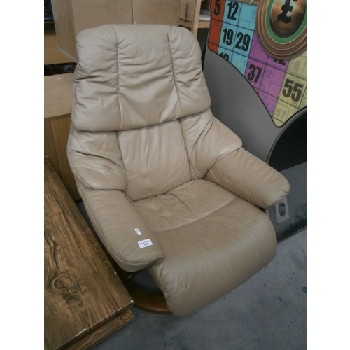 617 - A beige leather STRESSLESS recliner swivel armchair