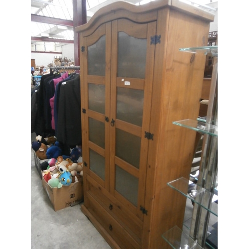 604 - A pine cabinet with glazed doors and 2 x lower drawers - no shelves