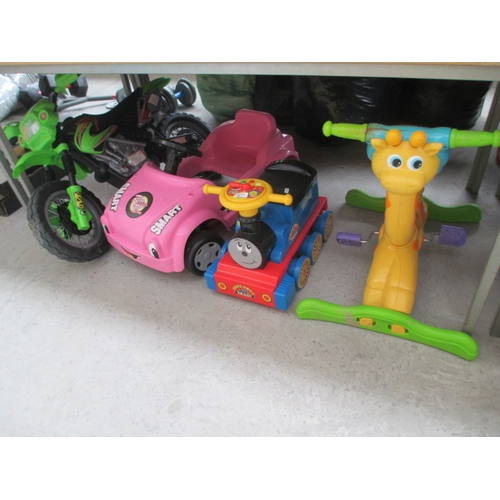 65 - Four kids sit on toys