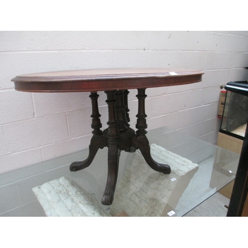 673 - An oval antique tilt top table on ornately carved pedestal - as found