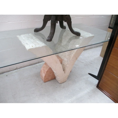 674 - A large glass topped dining table on composite stone base stand