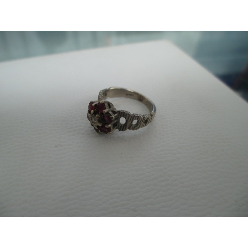 407 - 18ct white gold ring with six small red stones, weight 4.7grams