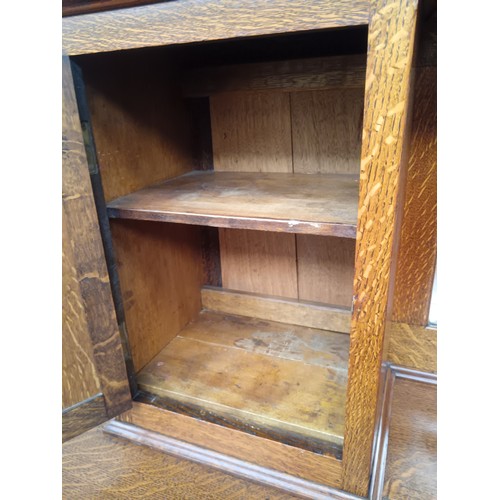 618 - A large antique solid oak mirror backed sideboard with 2 x upper cupboards and a 7 drawer base