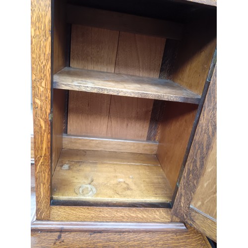 618 - A large antique solid oak mirror backed sideboard with 2 x upper cupboards and a 7 drawer base