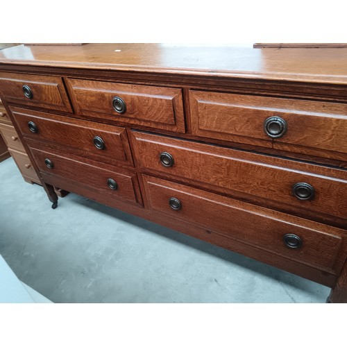 618 - A large antique solid oak mirror backed sideboard with 2 x upper cupboards and a 7 drawer base