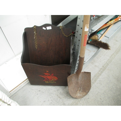 281 - A vintage wooden magazine rack and a long handled spade