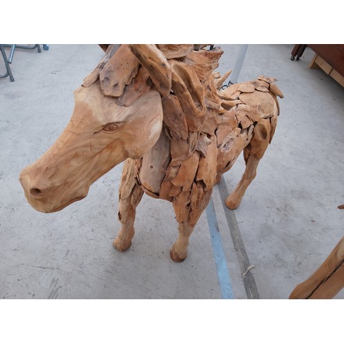 298 - Ornately carved wooden horse. Size Length 50