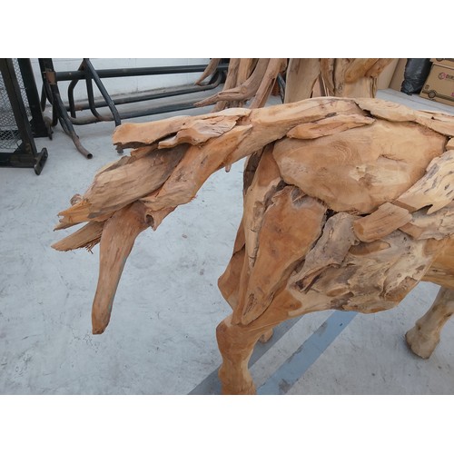 298 - Ornately carved wooden horse. Size Length 50