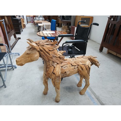 298 - Ornately carved wooden horse. Size Length 50