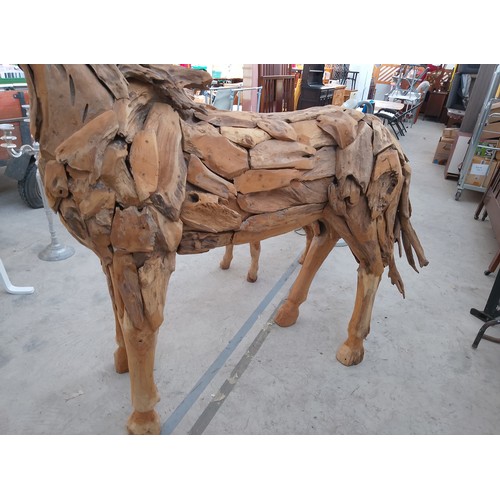 299 - Full sized ornately carved wooden horse. Size Length 88