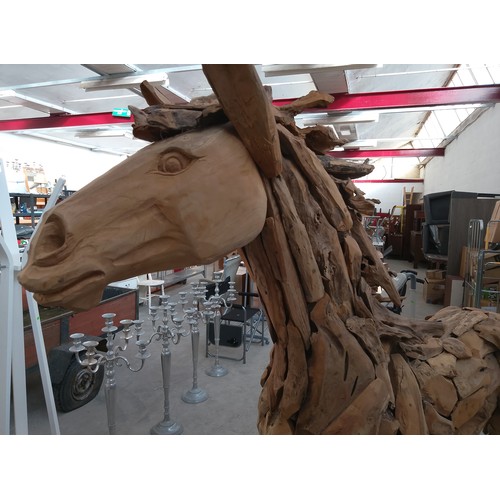 299 - Full sized ornately carved wooden horse. Size Length 88