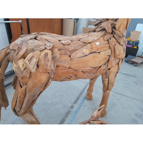 299 - Full sized ornately carved wooden horse. Size Length 88