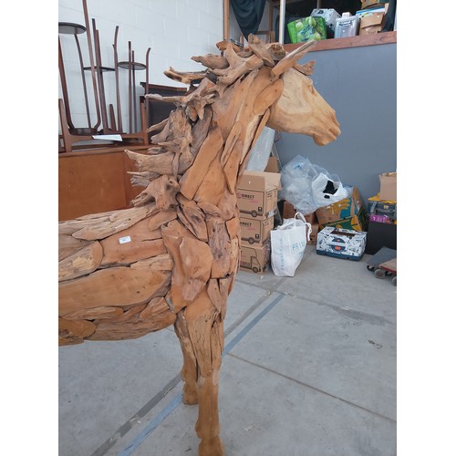 299 - Full sized ornately carved wooden horse. Size Length 88