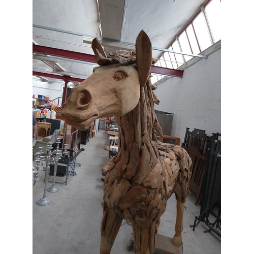 299 - Full sized ornately carved wooden horse. Size Length 88