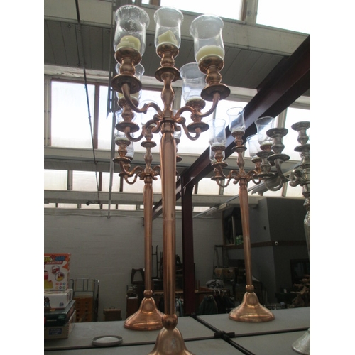 316 - Five arm rose gold coloured candelabra with storm glasses