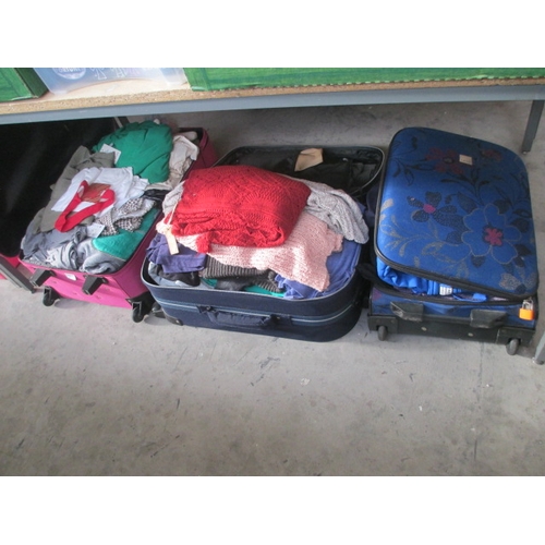 79 - Three suitcases of assorted clothing